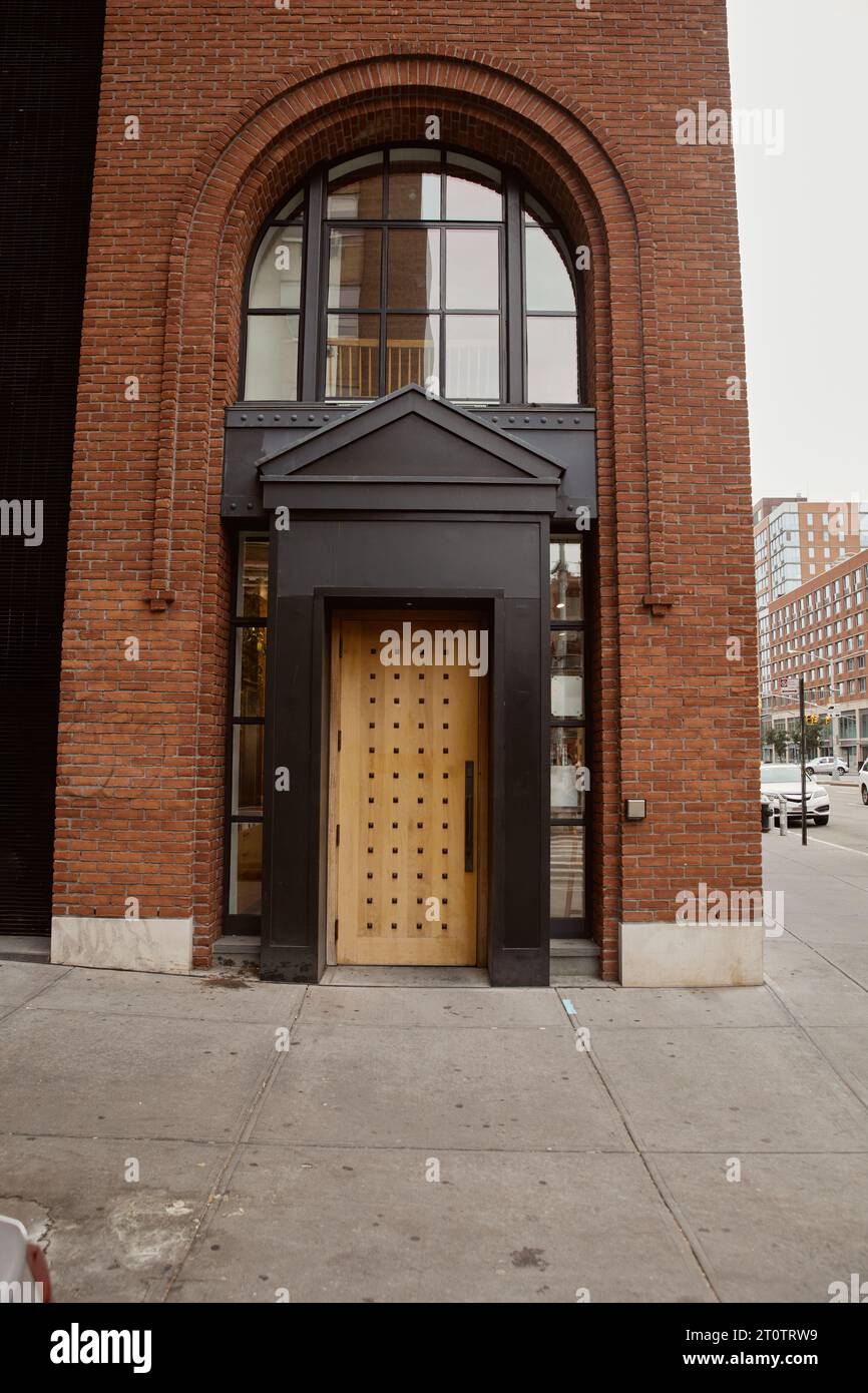 entrance of brick building with portico and arch window in downtown of