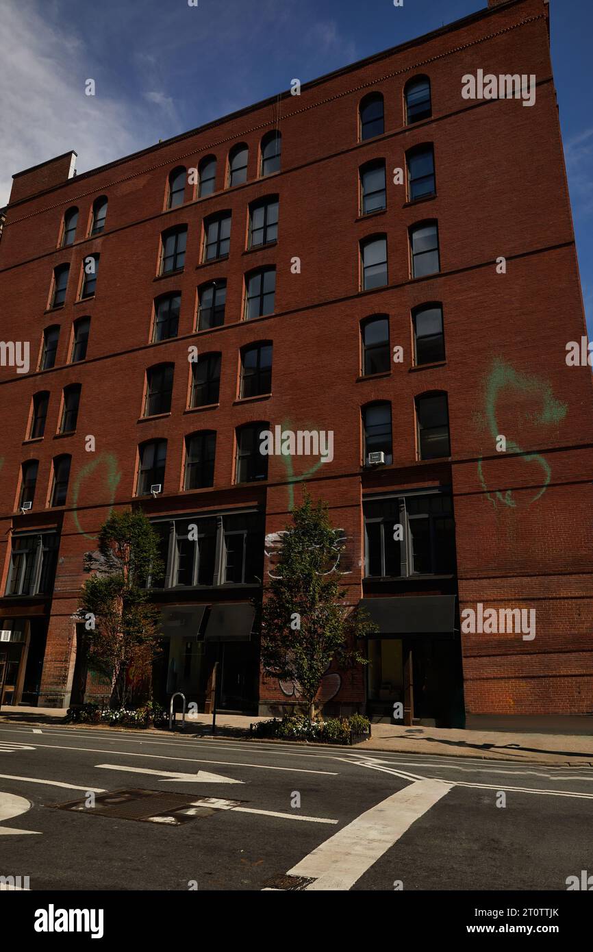 red brick building near trees and wide roadway in downtown of new york city, autumnal cityscape