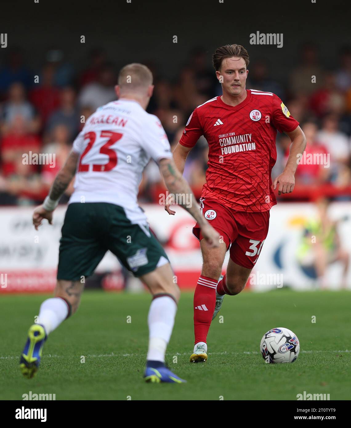 Crawley Town's Will Wright takes on Wrexham's James McClean during the 
