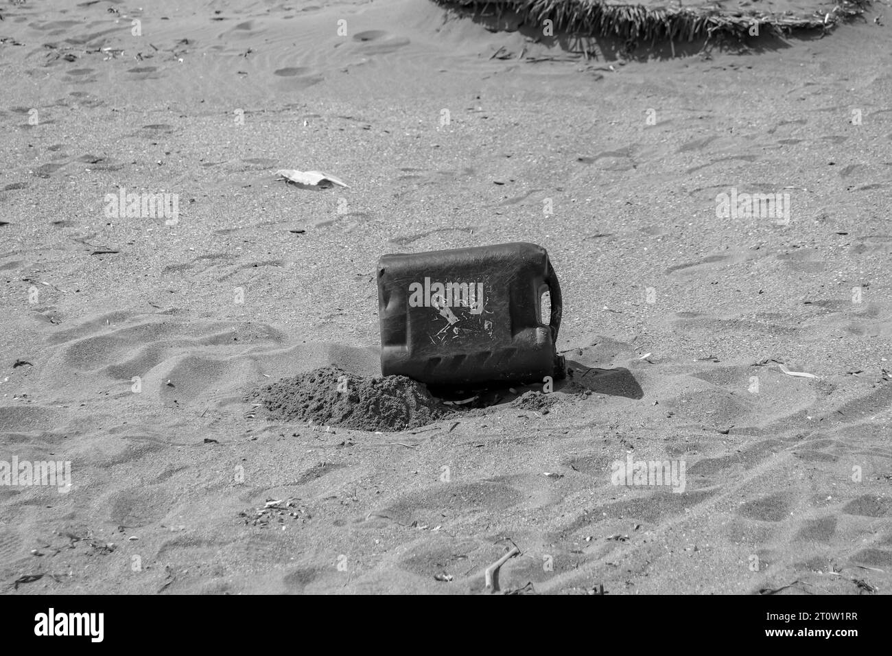 plastic trash thrown on beach sand creating dirt, trash and pollution near the ocean in nature. World environment day, ecological, pollution concept Stock Photo