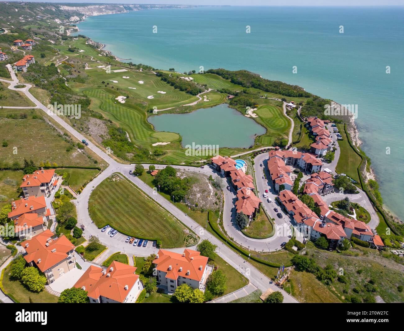 Aerial view of the golf course stretches out beneath, its lush green ...