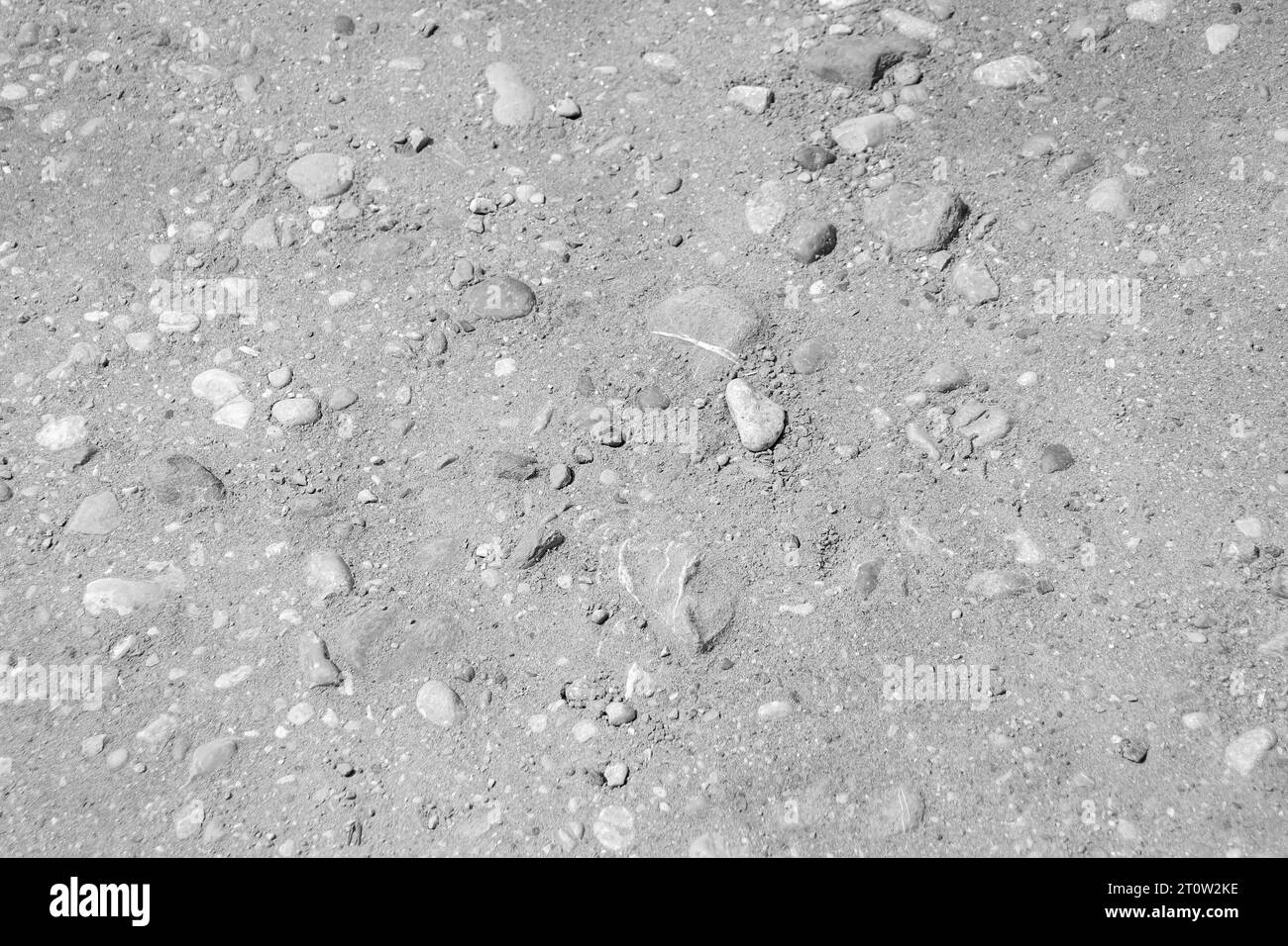 Black and white abstract background beach sand with rocks on the ground Stock Photo