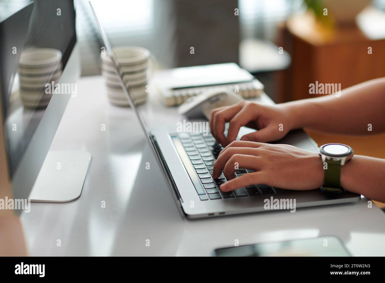 Hands of software developer coding on laptop at home Stock Photo