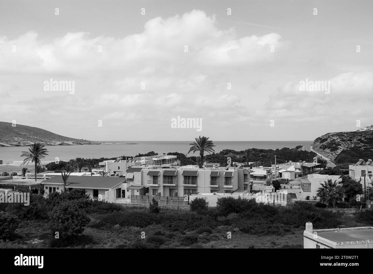 Black and white Oasis Prasonisi Hotel buildings beach front to Prasonisi beach, Greece, a meeting spot between the Mediterranean and the Aegean sea Stock Photo