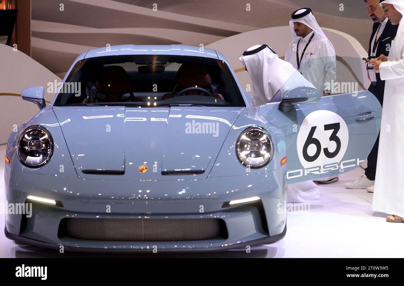 Doha, Qatar. 05th Oct, 2023. Qatari nationals look at a Porsche 911 GT3