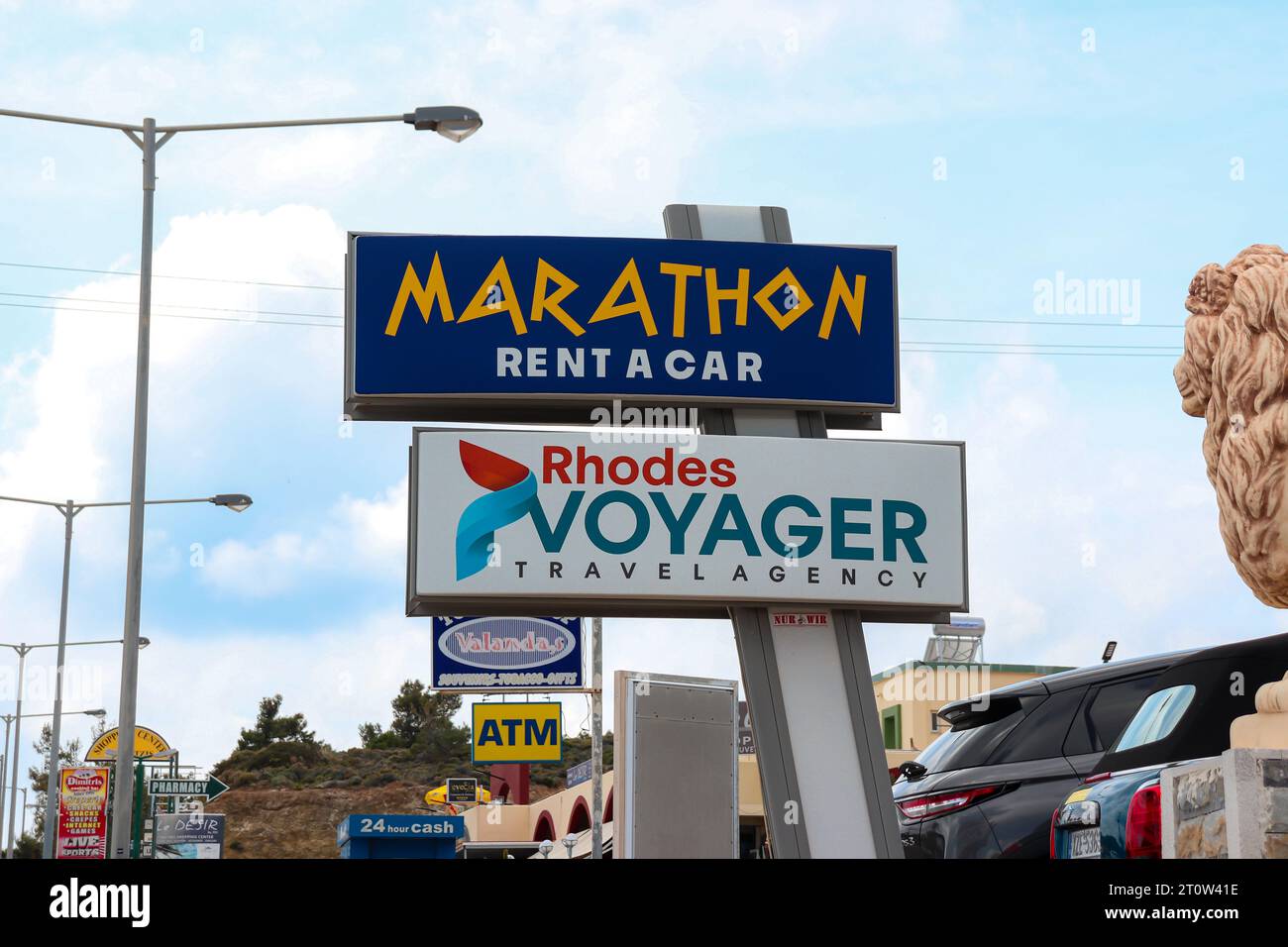Marathon Rent a Car business and Rhodes Voyager travel agency office sign informing tourist people of store location Stock Photo