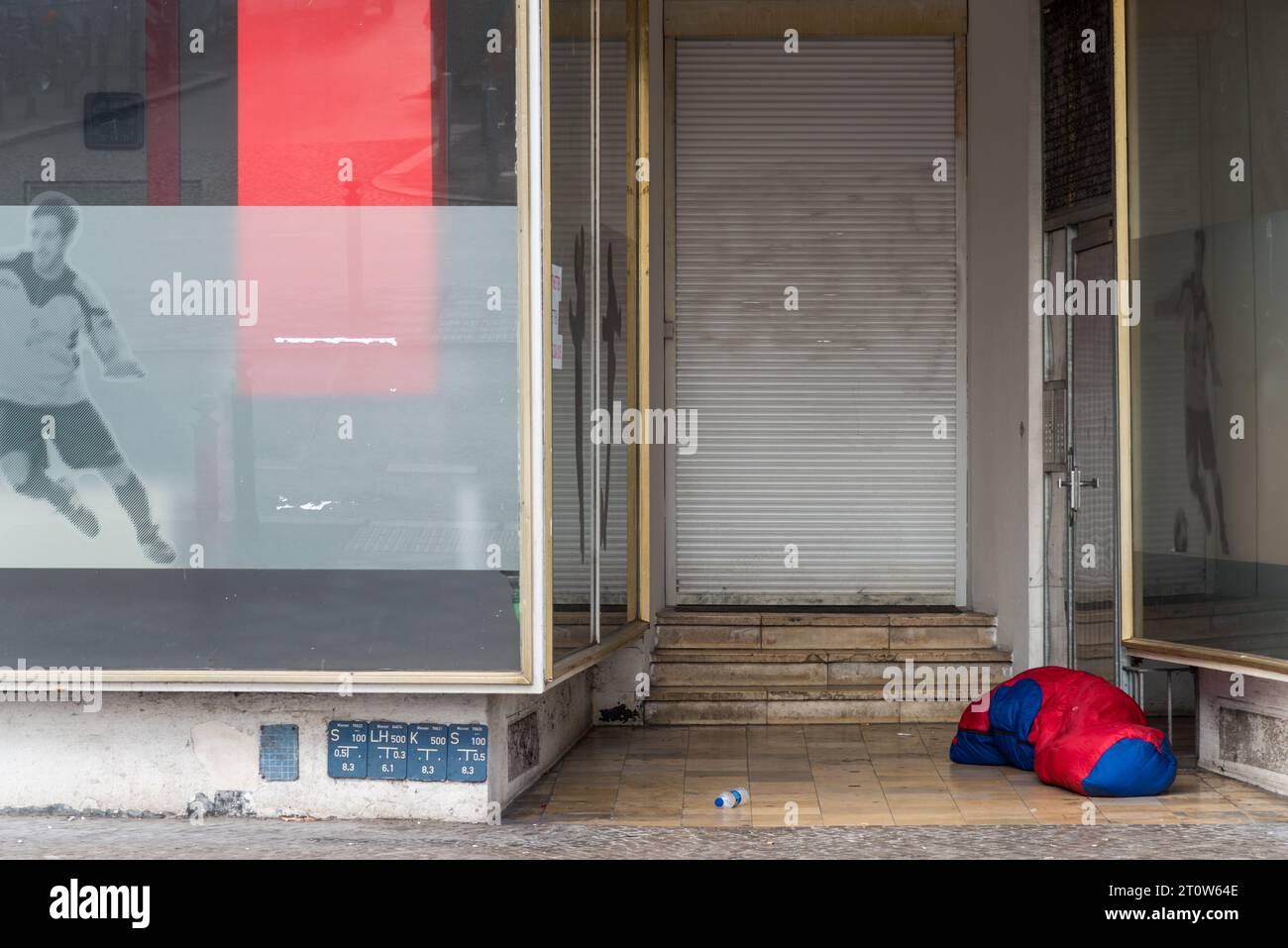 A sleeping bag of a homeless person in a house entrance Stock Photo