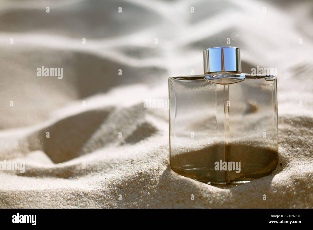 bottle of perfume on the sand Stock Photo