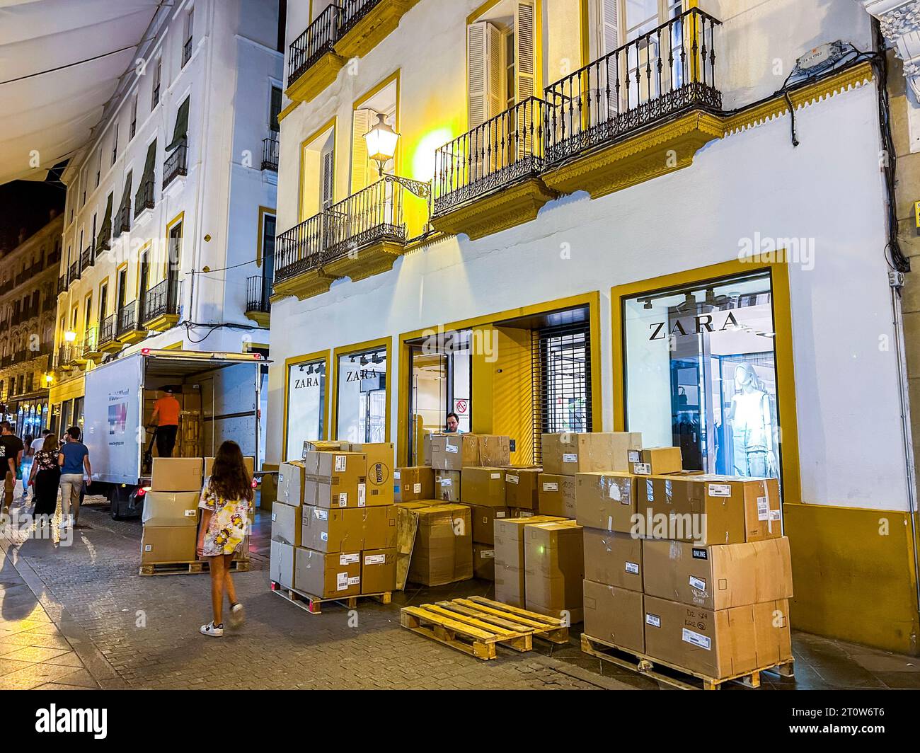 Seville, Spain, Street Scene, Fast Fashion Clothing Industry, UnLoading Boxes at Night, Zara Company Stock Photo