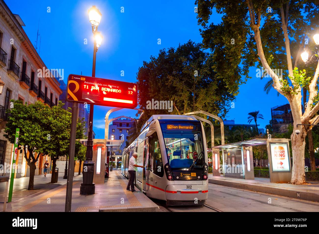 Seville, Spain, People, Public Transport, Tram, at Night, Lights, San Bernardo Station, Street Scene, neighborhoods Stock Photo