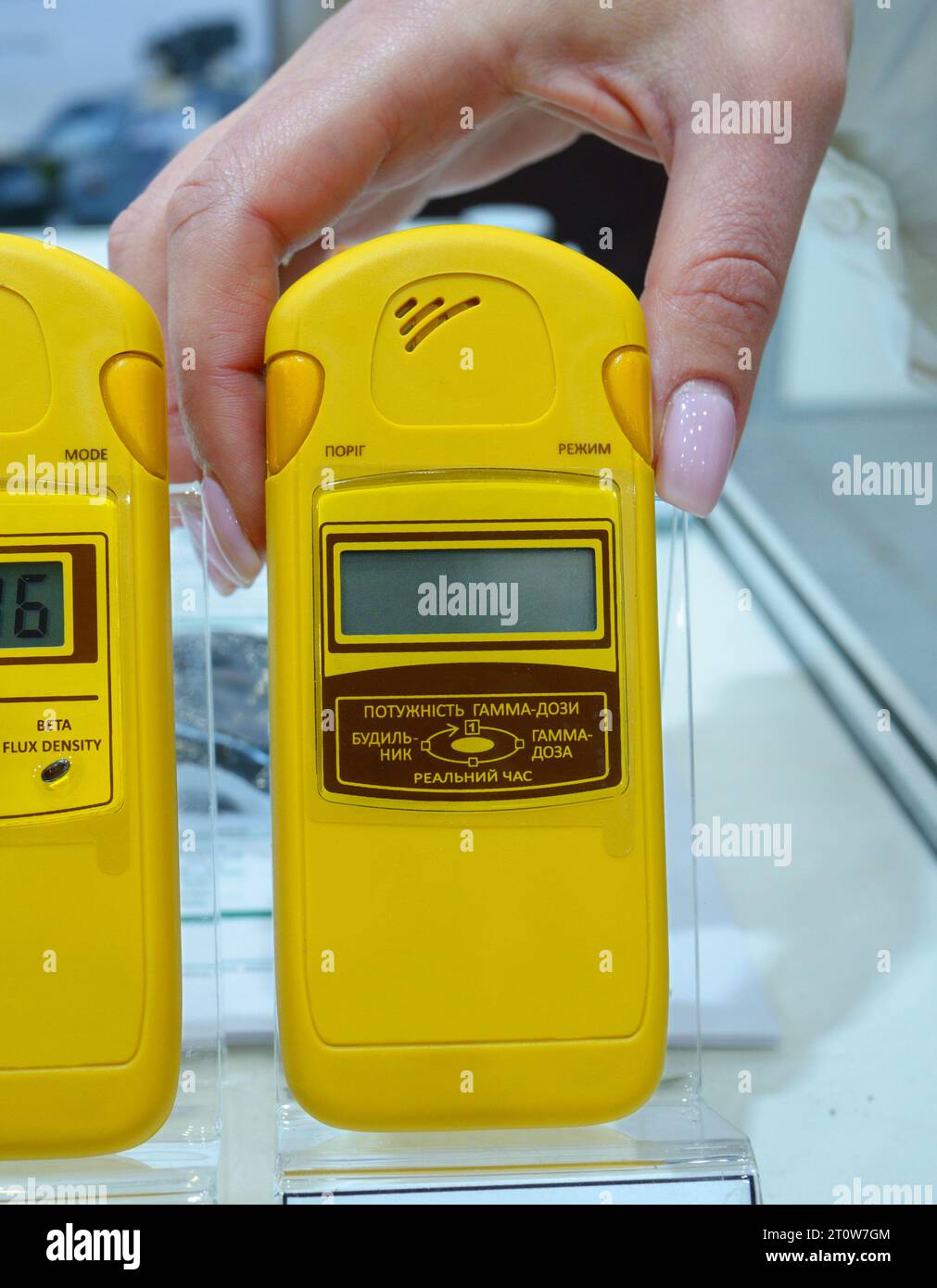 Woman hand holding personal dosimeter-radiometers for measuring levels ...