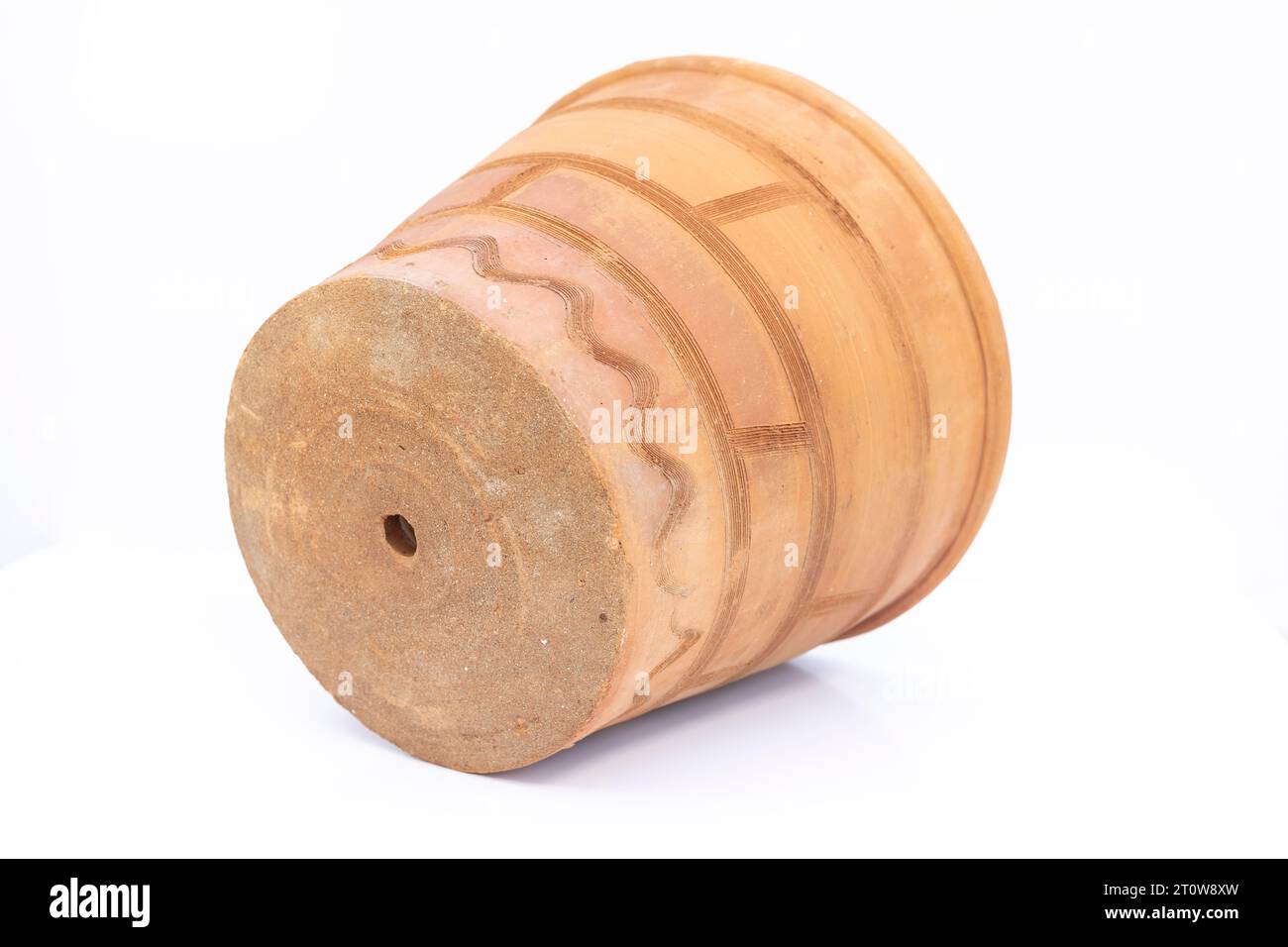 Large clay pot with drainage hole isolated on white background Stock