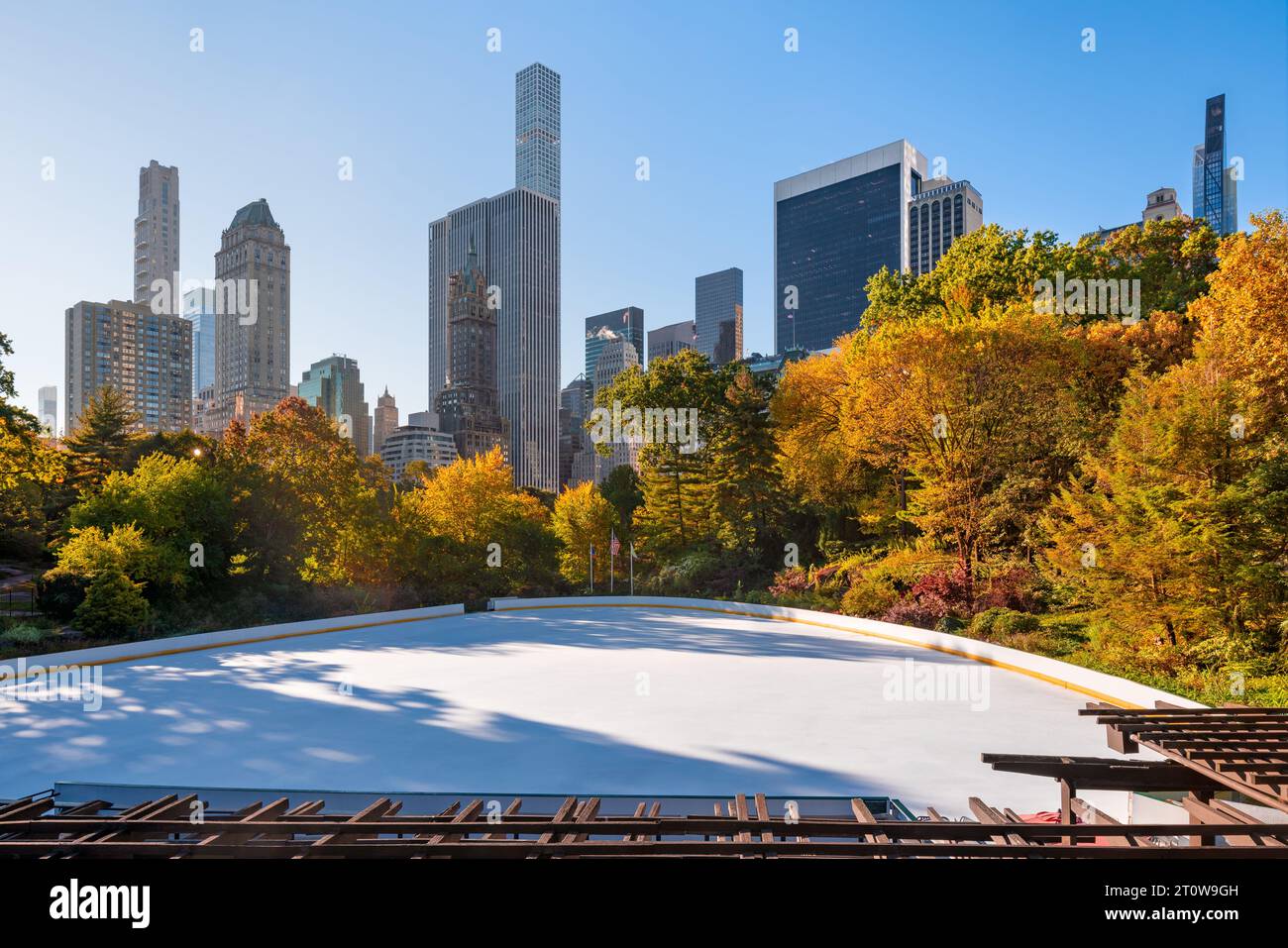 Skating rink in Central Park in autumn with 5th Avenue skyscrapers. Upper East Side, Manhattan, New York City Stock Photo