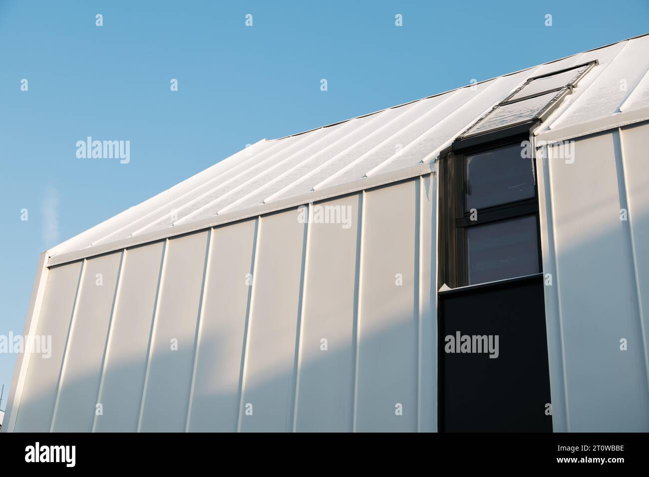 Metal hangar against the blue sky in winter snow day Stock Photo