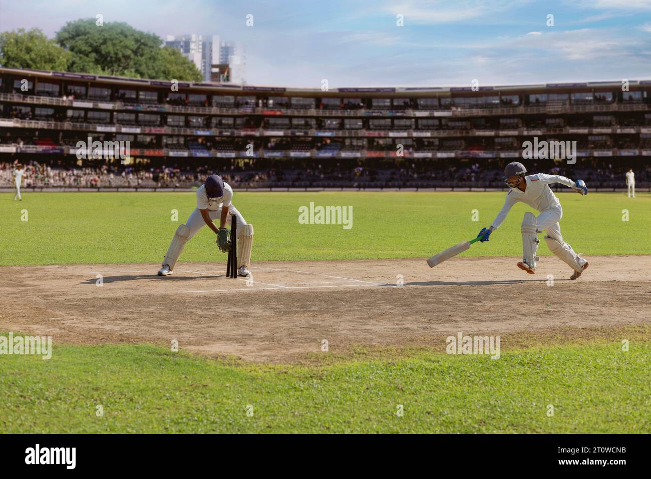 wicket keeper trying to run out a batsman before he reaches the crease during cricket match
