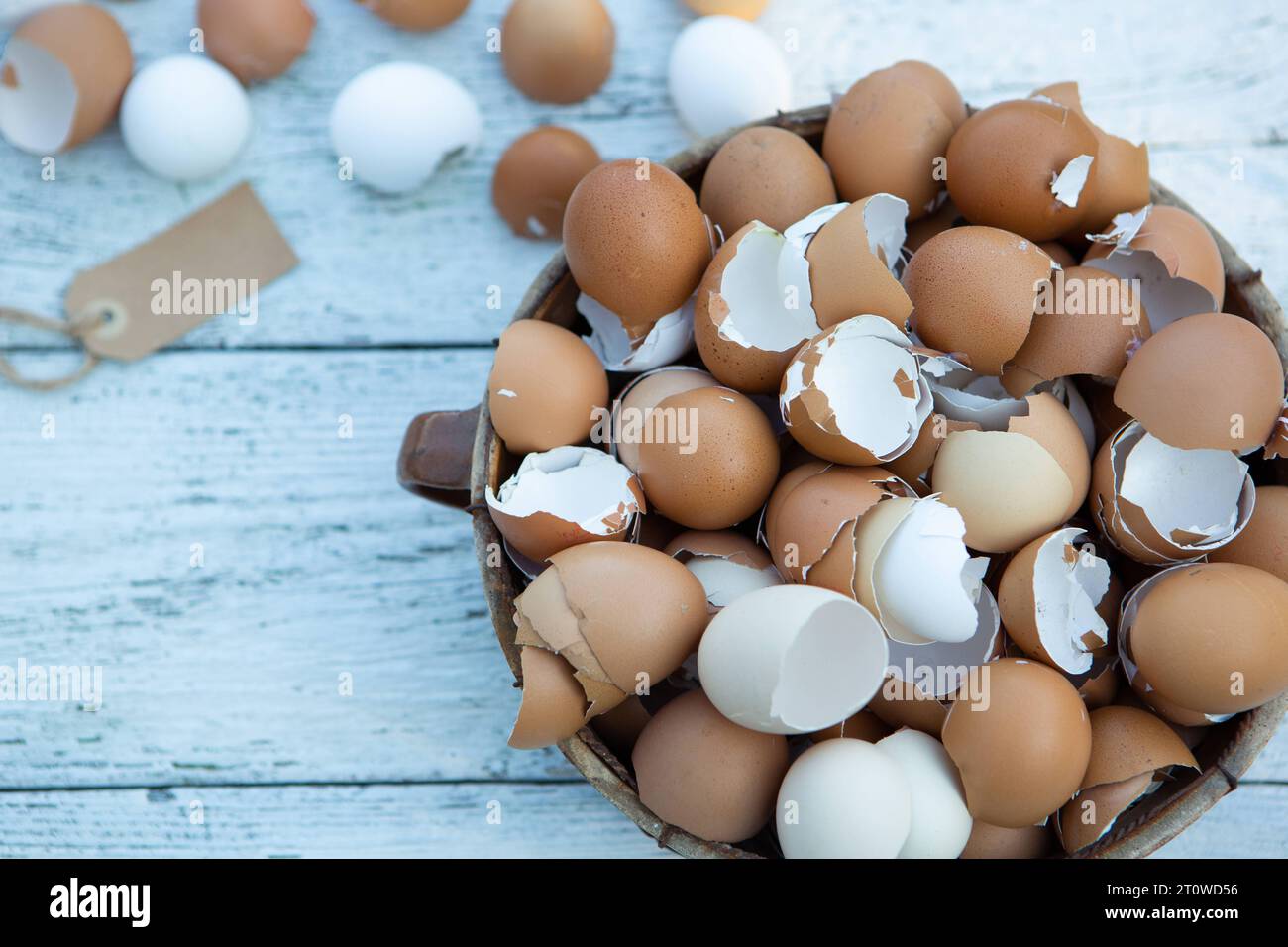 10 February 2023: Easter, broken eggs shells on light wood in a basket *** Ostern, zerbrochene Eier Schalen auf hellem Holz in einem Korb Stock Photo