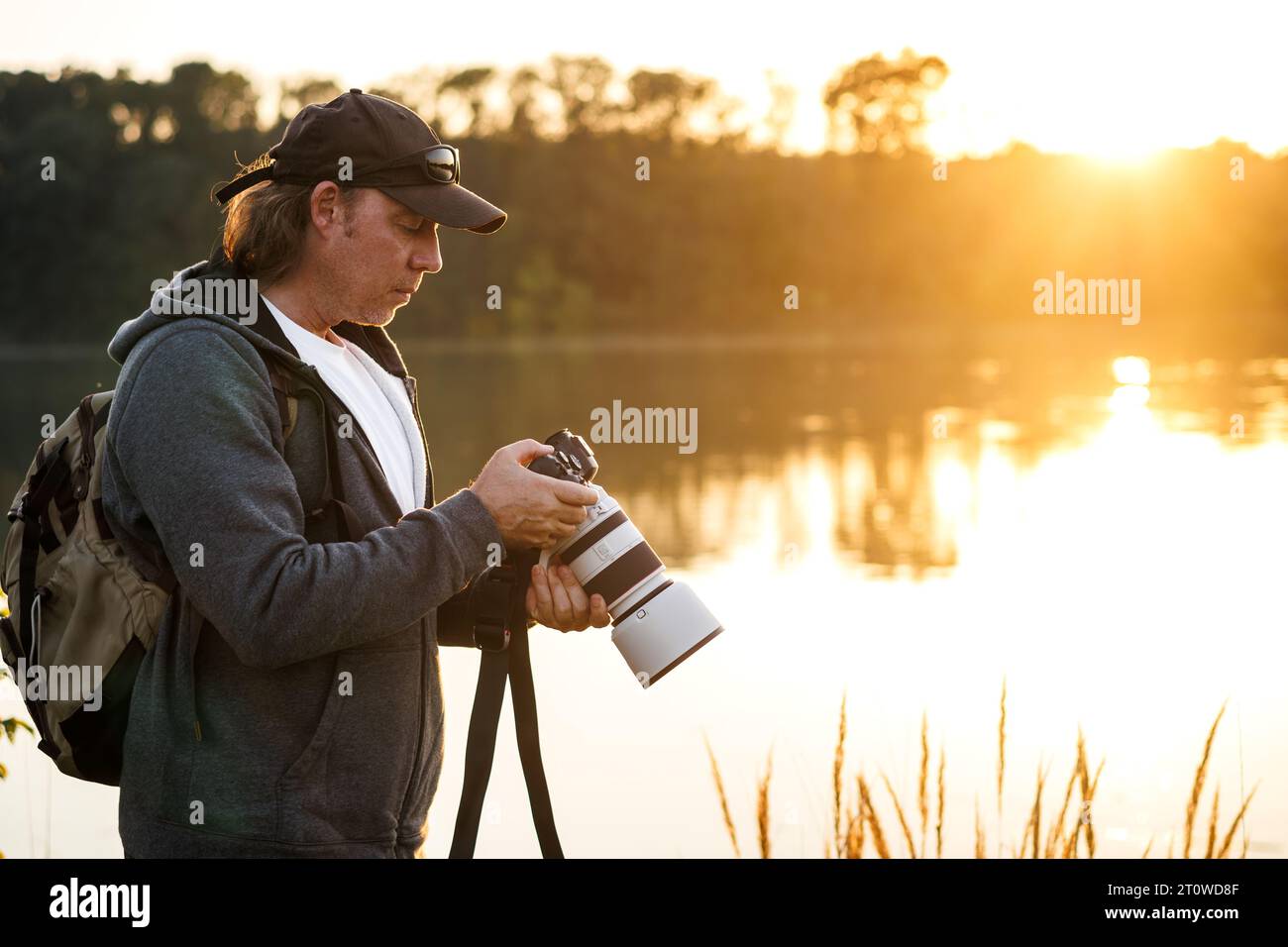 Landscape and wildlife photographer looks at photos on camera screen ...
