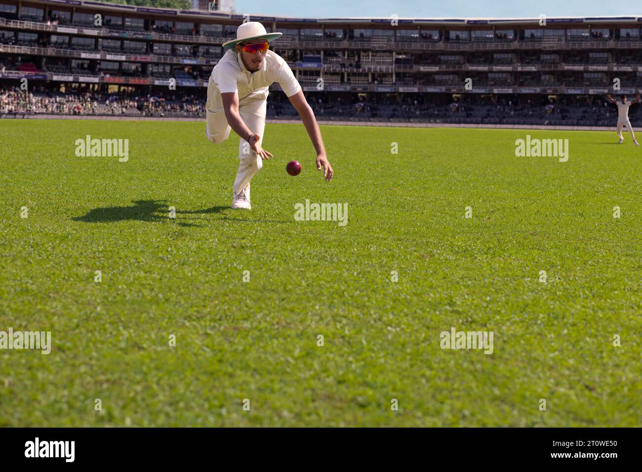 A fielder about to catch the  ball during a cricket match Stock Photo