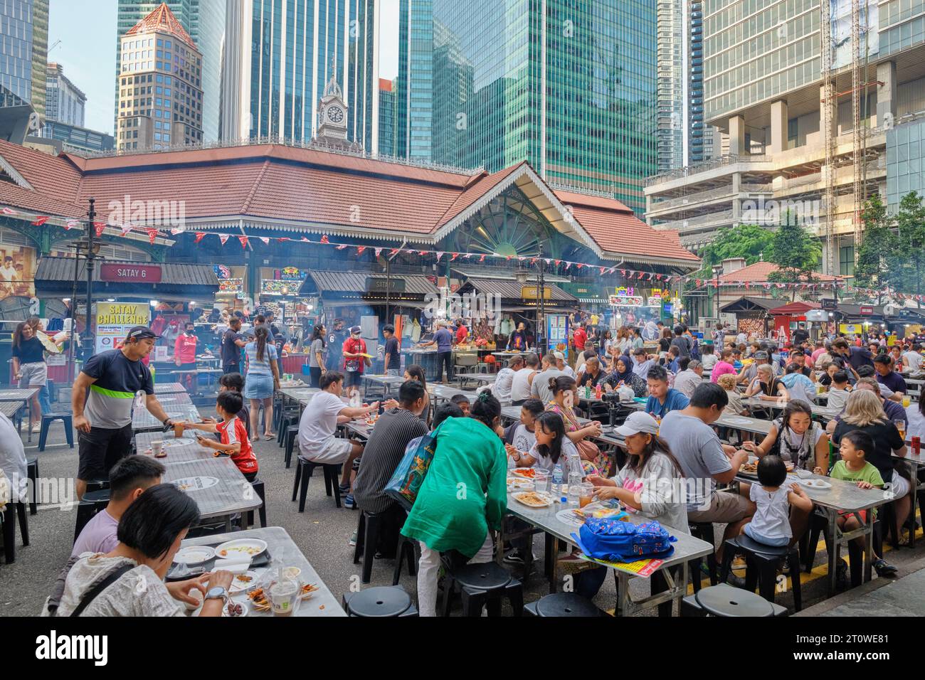 A crowd of happy patrons eating out in so-called Satay Street outside Lau Pa Sat hawker center, Singapore, Southeast Asia Stock Photo