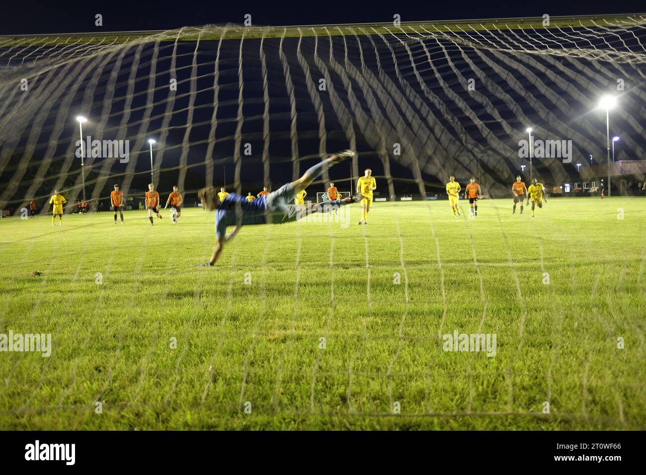 Stood behind the football goal,  for a penalty,  keeper diving,  but still a goal at W&CFC , Hitherroft sports pak, Wallingford,  UK Stock Photo