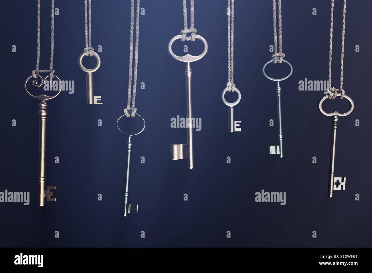 A collection of various keys hanging on a twine, making rustic and vintage vibe Stock Photo