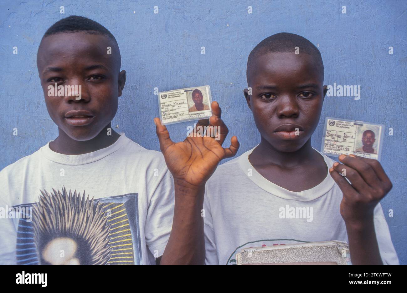 Liberia, Monrovia; portrait of ex child soldiers showing their school passes.. Stock Photo