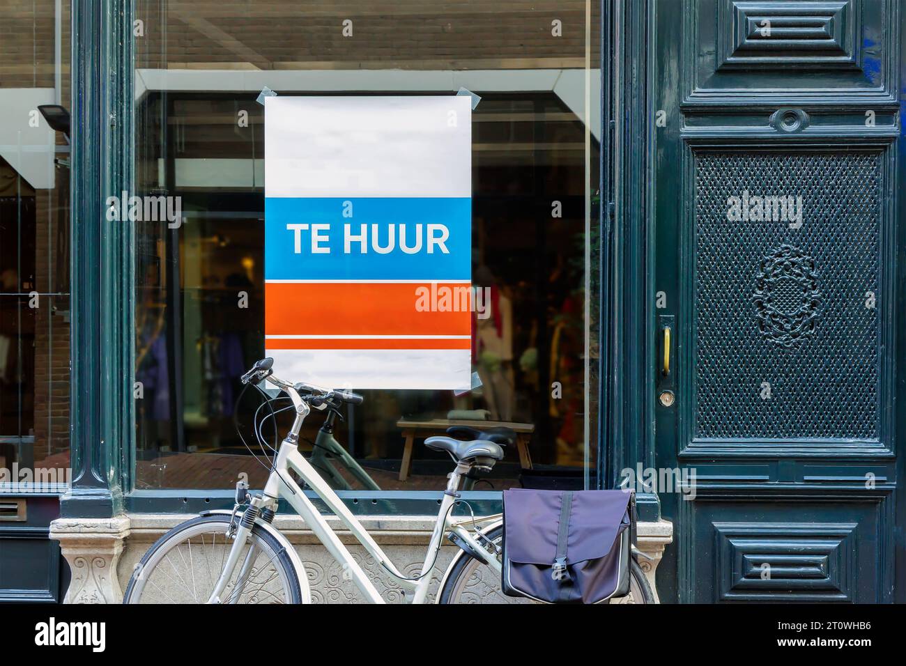 Dutch sign with the text 'for rent' on an empty store window with ...