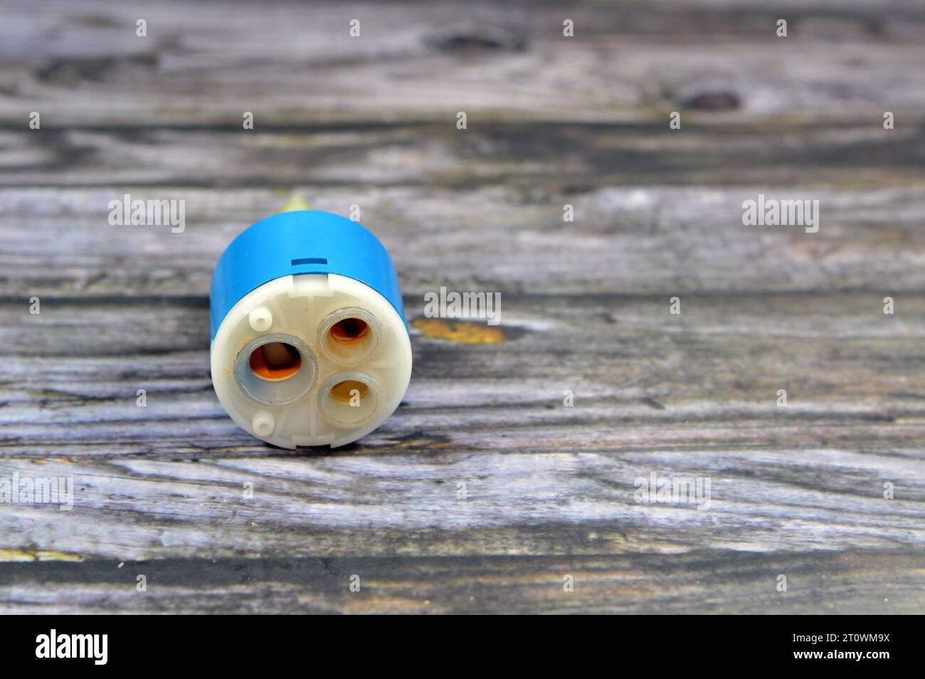 A used broken shower faucet tap body cartridge parts of plastic that