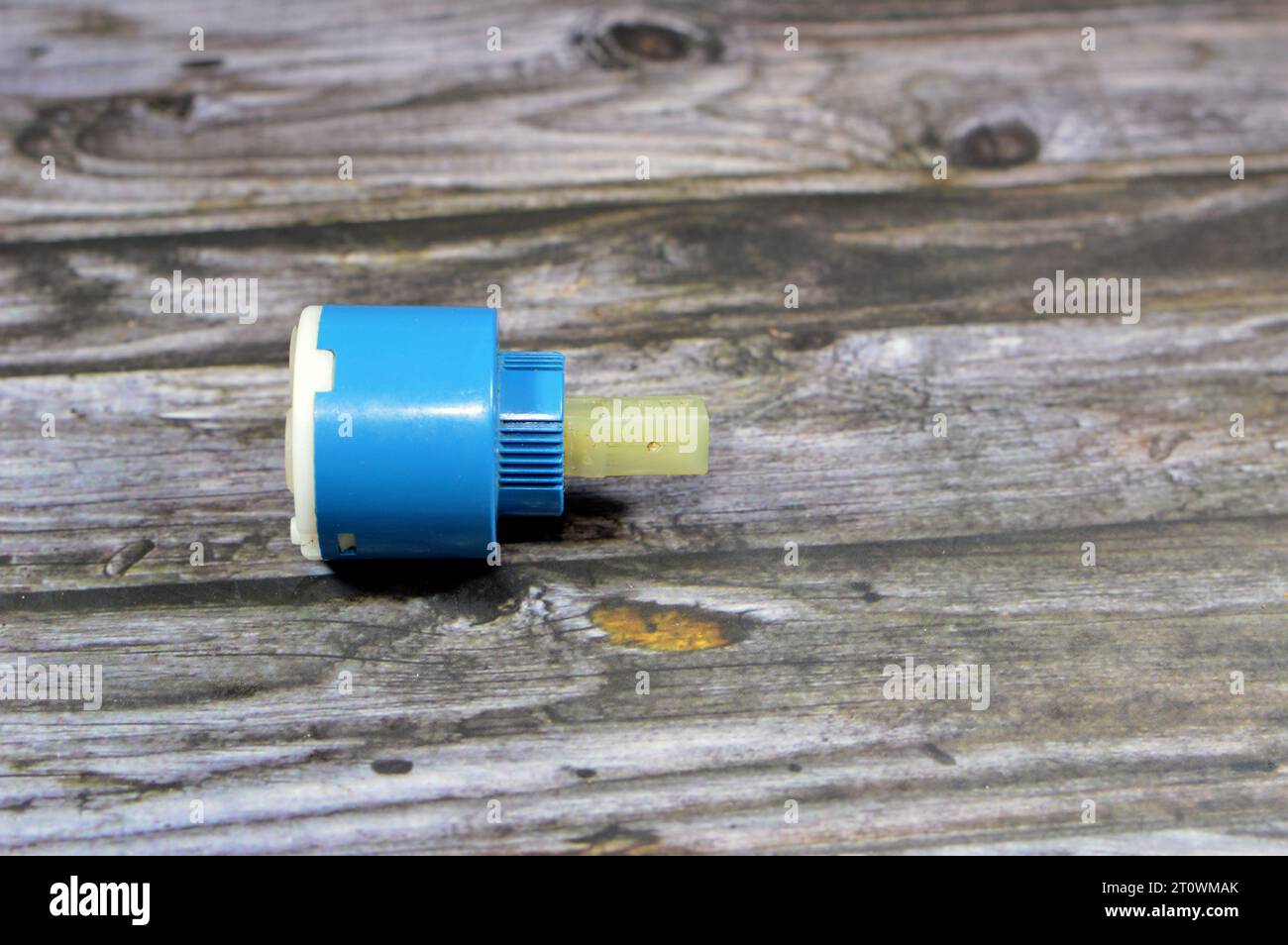 A used broken shower faucet tap body cartridge parts of plastic that