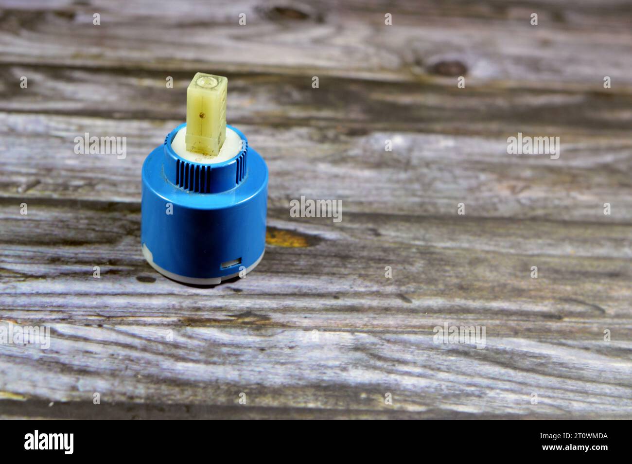 A used broken shower faucet tap body cartridge parts of plastic that needs to be fixed or