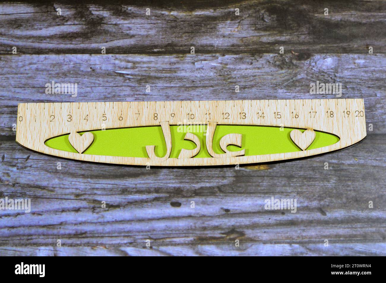 Translation of Arabic name on the ruler (Adel), Arabian common names on wooden rulers, a rule, line gauge, instrument used to make length measurements Stock Photo