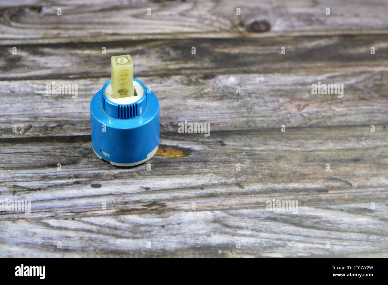 A used broken shower faucet tap body cartridge parts of plastic that