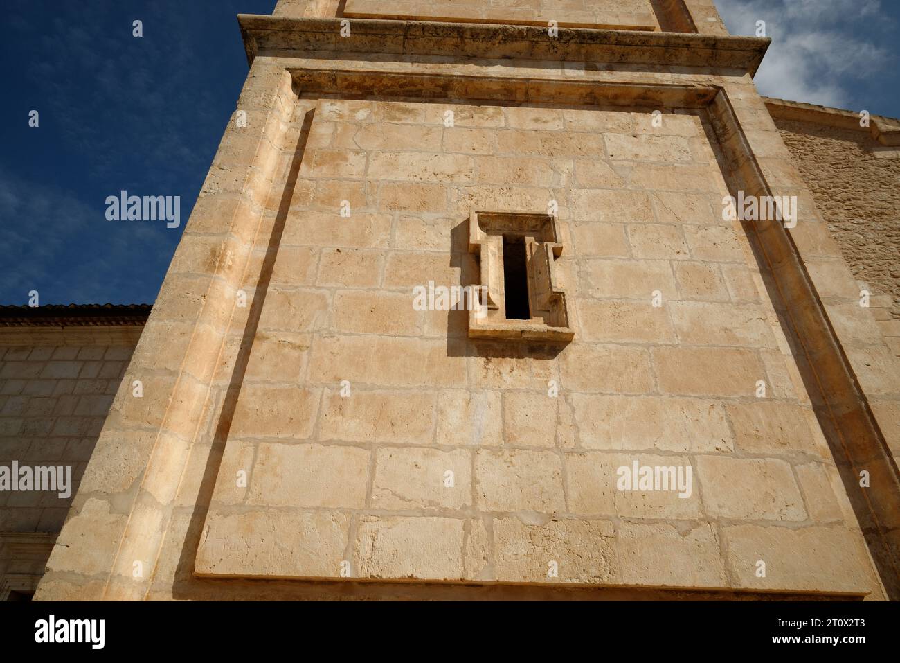Architectural detail. Nice carved stone around a slit window opening. Letter I for illustration purpose. Stock Photo
