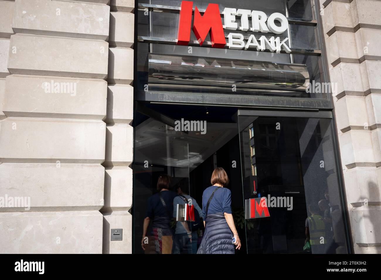 Members of the public and the exterior of Metro Bank on Piccadilly, on 9th October 2023, in London, England. Metro Bank is launching a fresh cost-cutting drive after the lender secured a £925m rescue package from investors over the weekend. Metro was the UK’s first new high street lender in 150 years when it first opened in 2010. It has confirmed overnight that customers had started to pull their money out in recent days amid worries over its financial health. Stock Photo