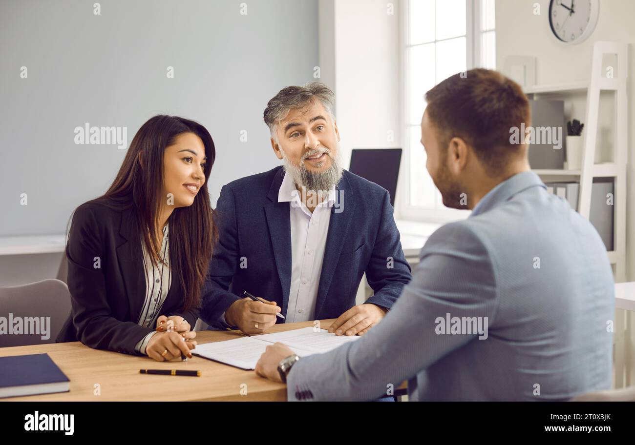 Business people discussing new project, reaching agreement and going signing a contract. Stock Photo