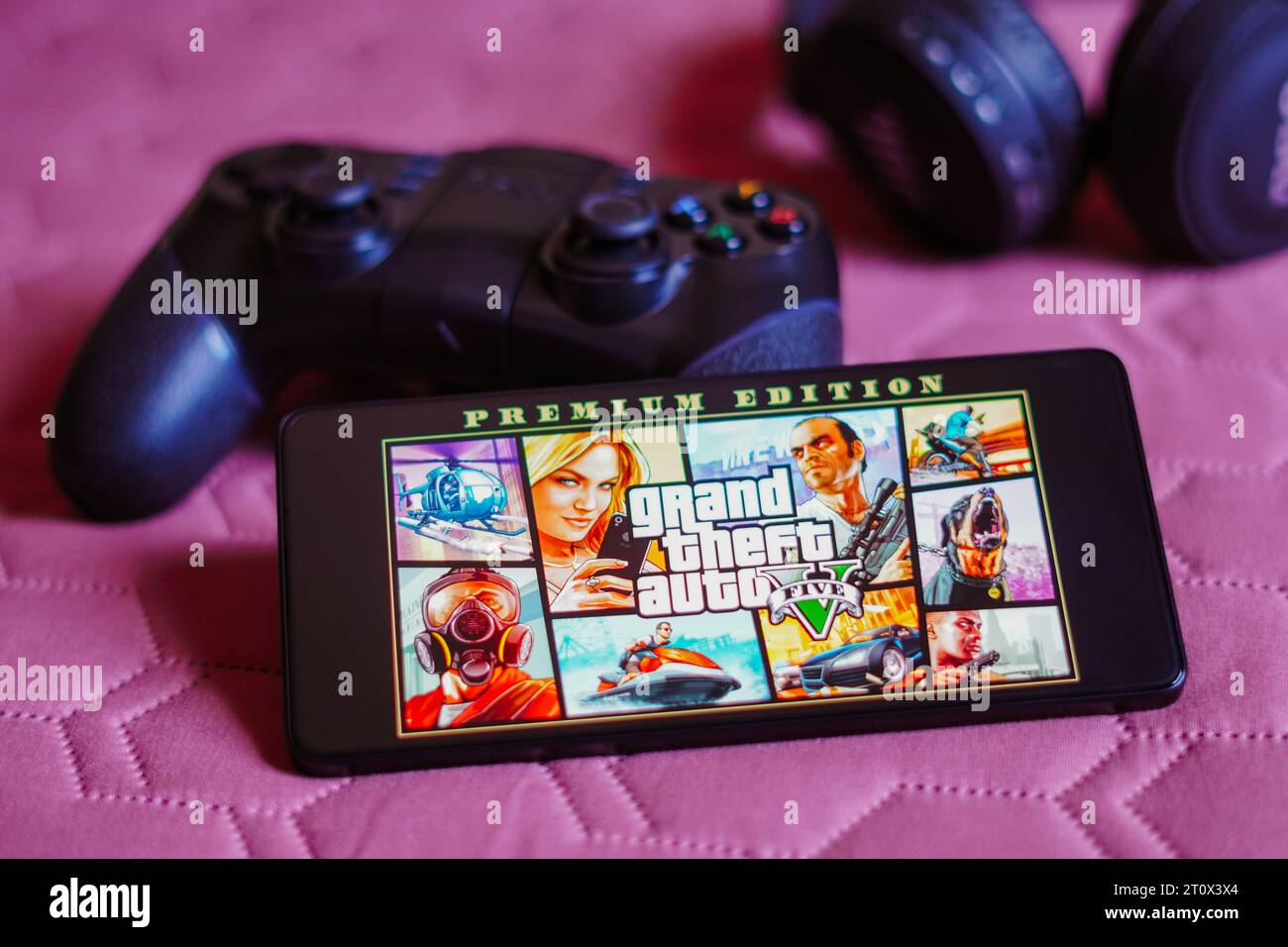 Brazil. 09th Oct, 2023. In this photo illustration, the Grand Theft Auto V (GTA) logo is displayed on a smartphone screen, next to a gamepad. Credit: SOPA Images Limited/Alamy Live News Stock Photo
