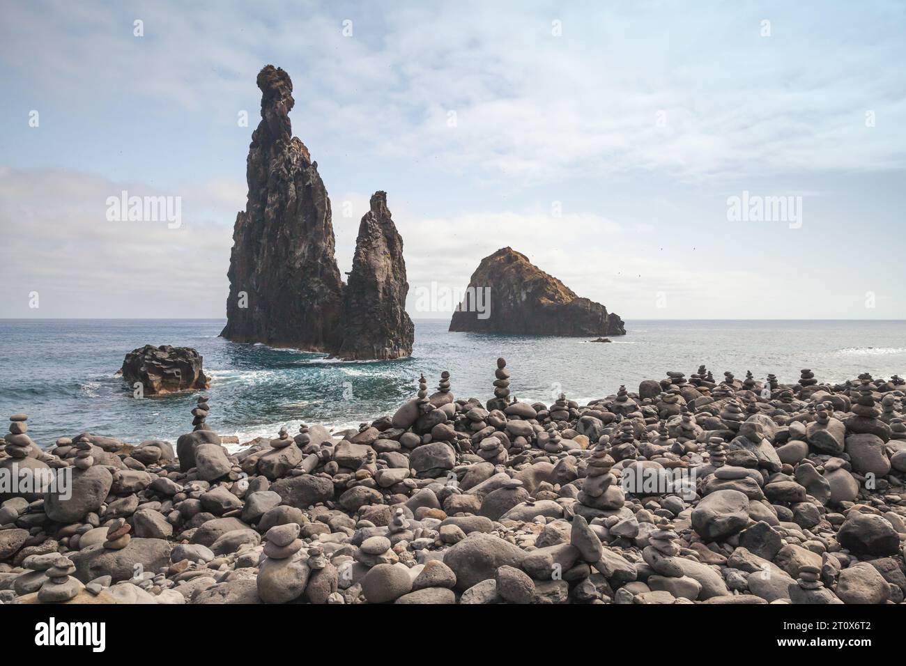 Pebble beach and dark rocky Islets of the Ribeira da Janela, Madeira island, Portugal Stock Photo