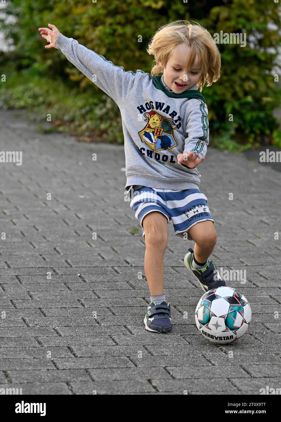 Boy, blond, 5 years, plays football, kicks, Stuttgart, Baden-Wuerttemberg, Germany Stock Photo