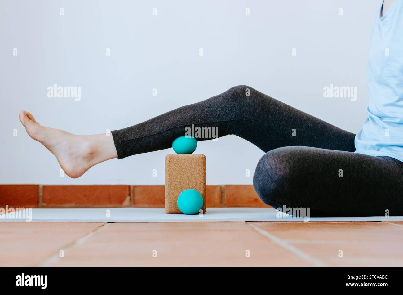 Calf muscle on therapy massage ball on cork block for myofascial release and hydration. Concept