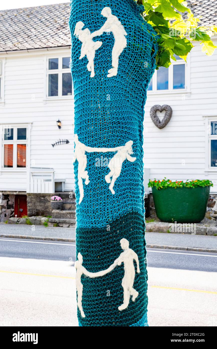 Local villagers have knitted 'coats' for their trees, which are quite the tourist attraction! Eidfjord Kommune, Vestland, Norway Stock Photo