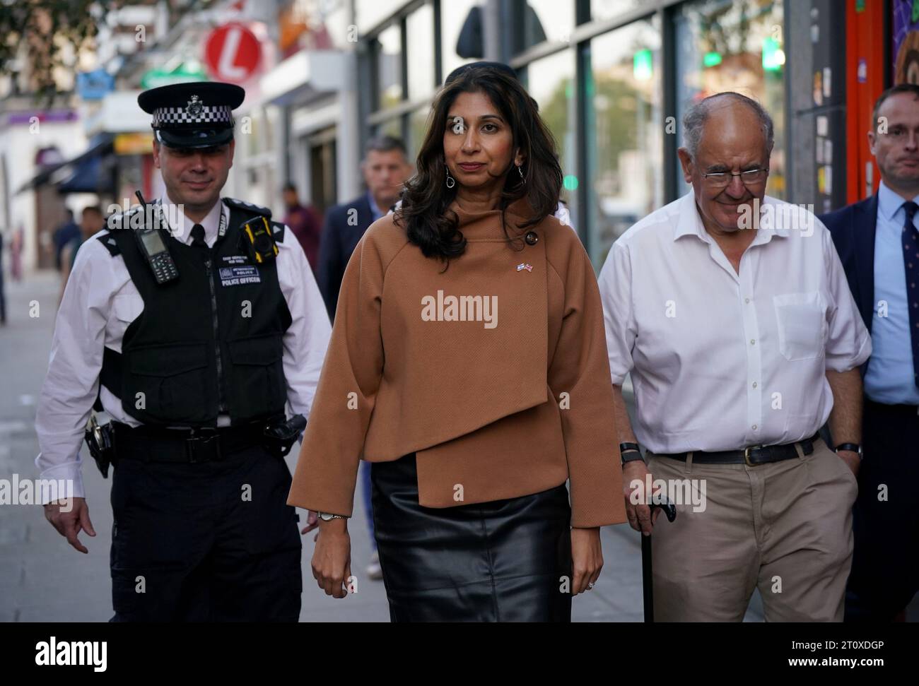 Home Secretary, Suella Braverman walks along Golder Green Road after