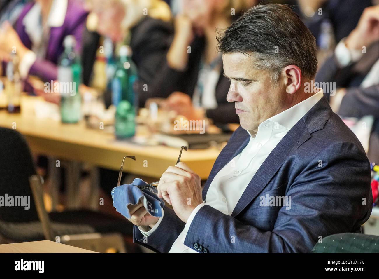 Hofheim, Germany. 09th Oct, 2023. Boris Rhein (CDU), Minister President of Hesse, sits at the state conference and cleans his glasses. The state committee of the CDU-Hessen gives the Prime Minister of Hesse (CDU) a grandiose reception at its meeting in the Stadthalle. The CDU emerges as the clear winner of the state elections in Hesse. Credit: Andreas Arnold/dpa/Alamy Live News Stock Photo