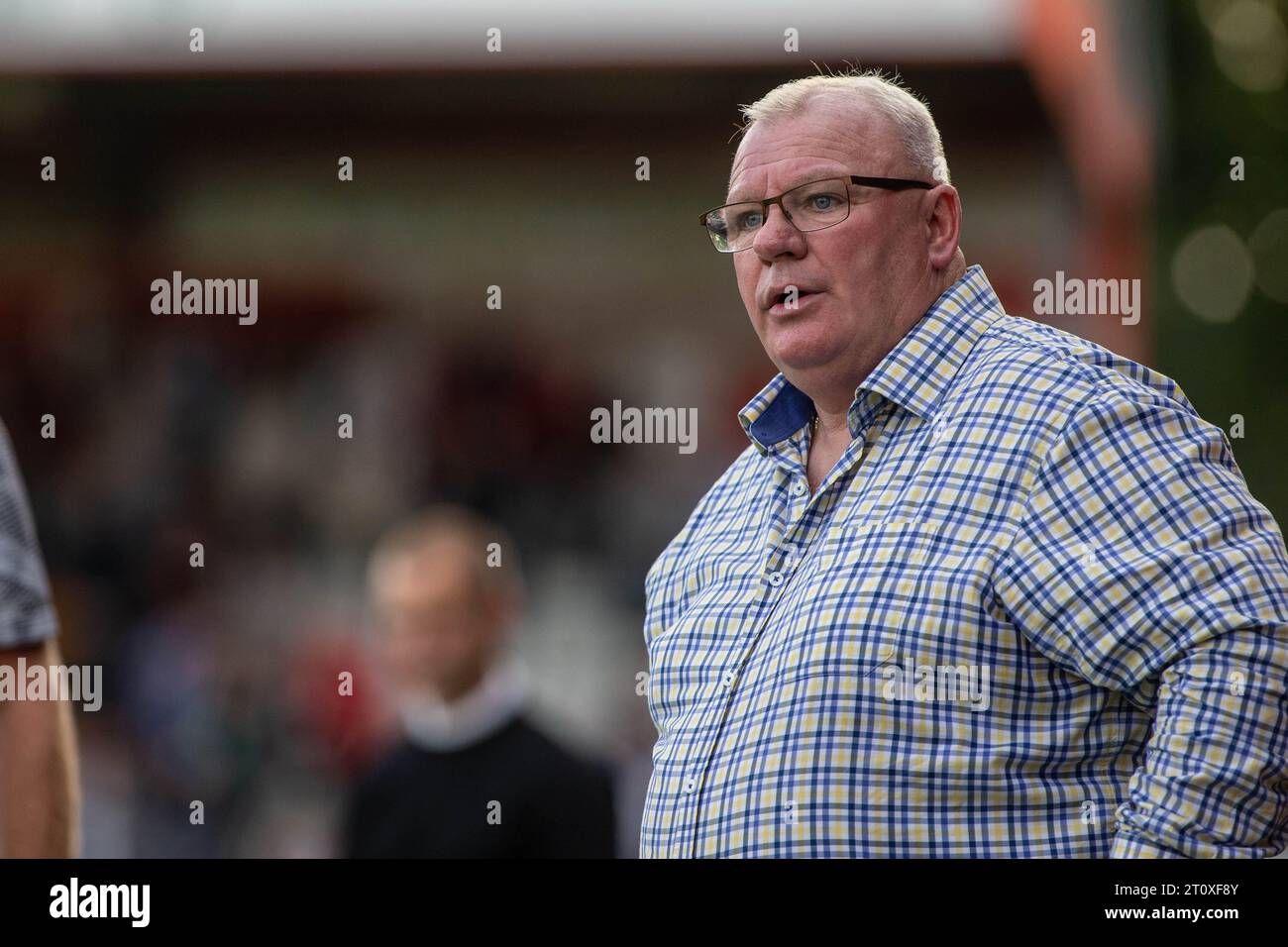 Football manager Steve Evans on touchline during match whilst head