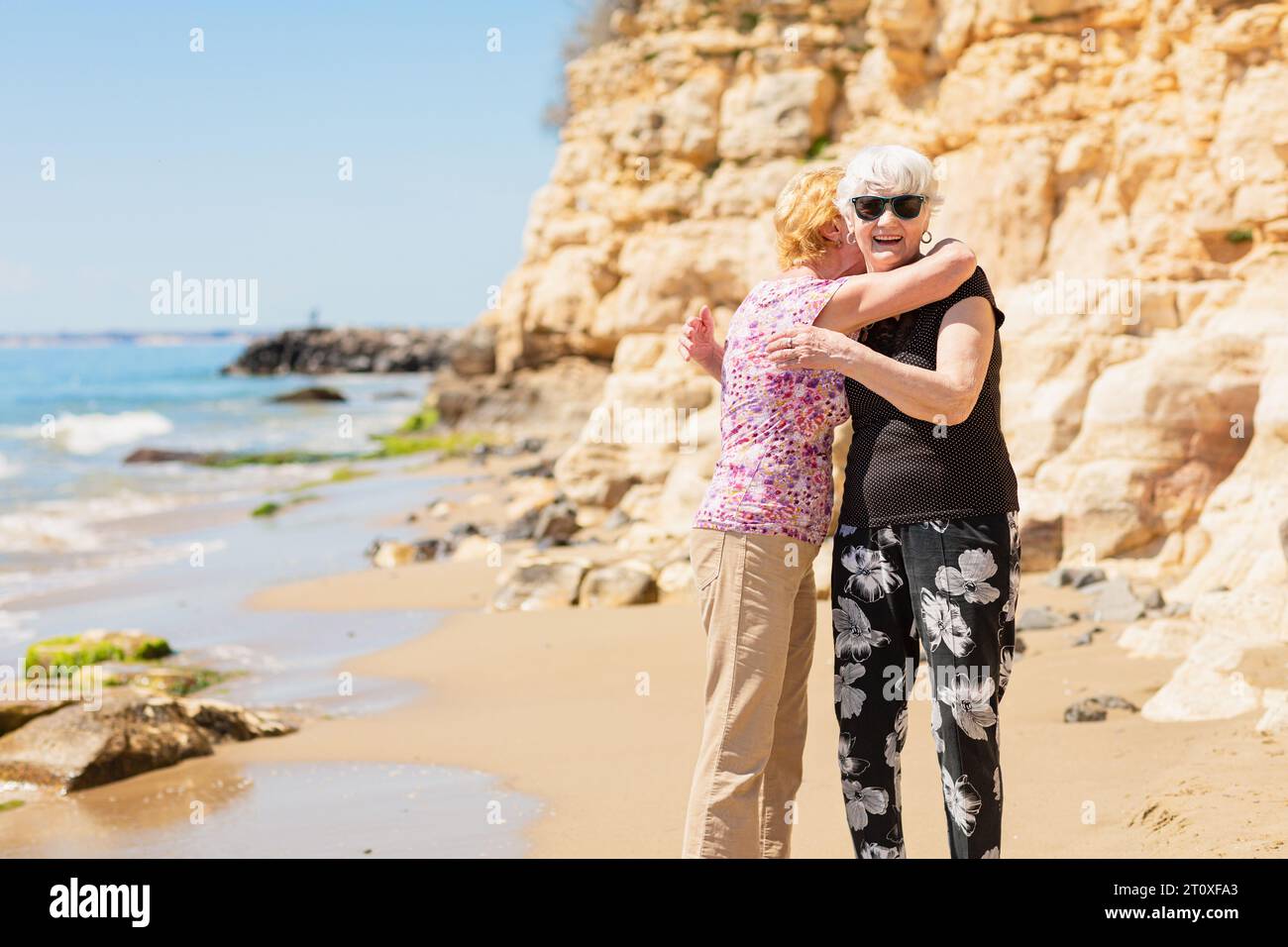 Woman walking rocky beach older hi-res stock photography and images - Alamy