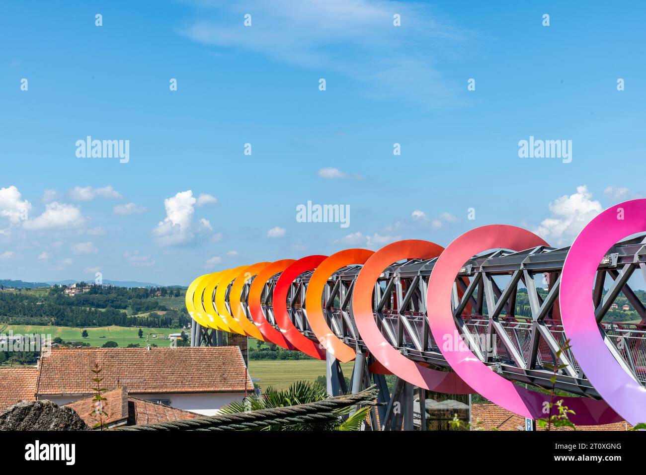 Pecciola, Italy-June 8, 2023; Colorful steel structure of walkway and artwork Endless Sunset by Patrick Tuttofuoco which shape alludes to circularity Stock Photo