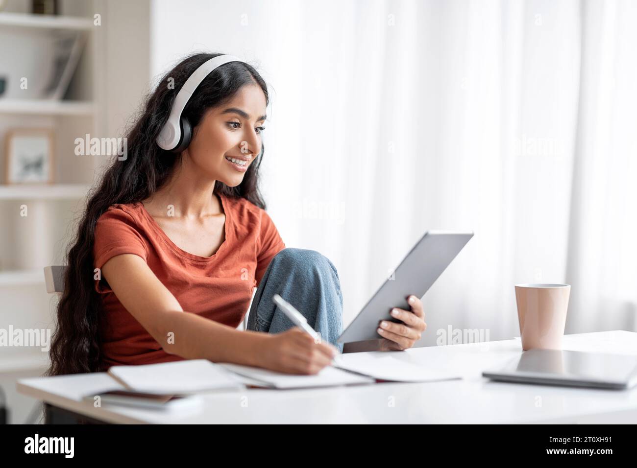 Student Young Indian Woman Using Digital Tablet, Headphones Stock Photo