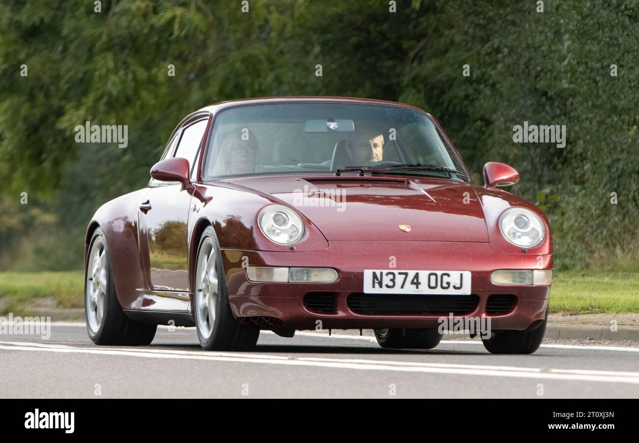 Bicester,Oxon.,UK - Oct 8th 2023: 1996 red Porsche 911 Carrera     classic car driving on an English country road. Stock Photo