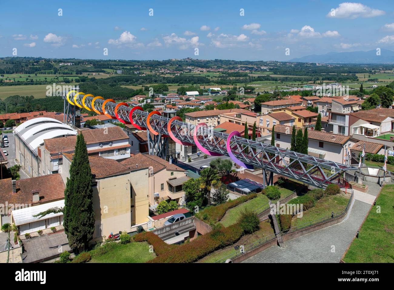 Pecciola, Italy-June 8, 2023; Colorful steel structure of walkway and artwork Endless Sunset by Patrick Tuttofuoco which shape alludes to circularity Stock Photo