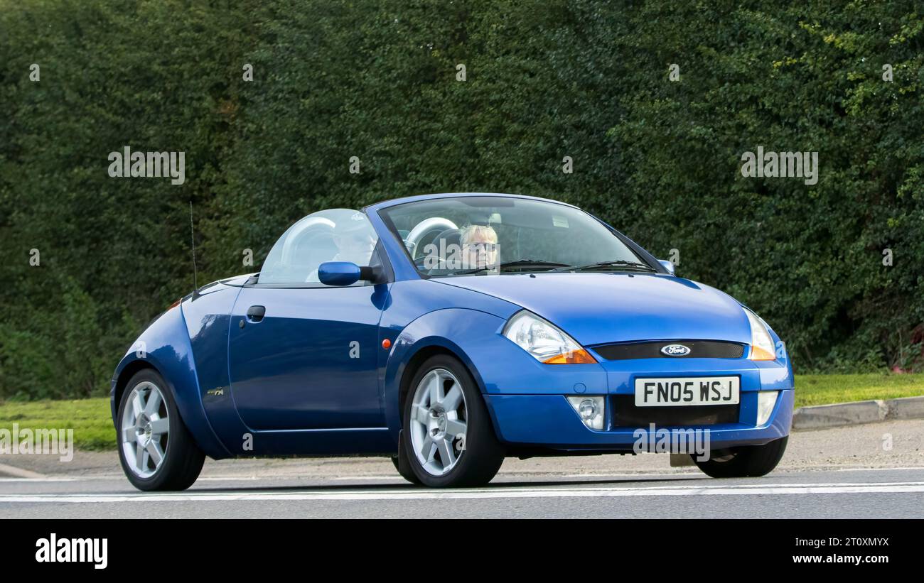 Bicester,Oxon.,UK - Oct 8th 2023: 2005 blue convertible Ford Ka classic car driving on an English country road. Stock Photo