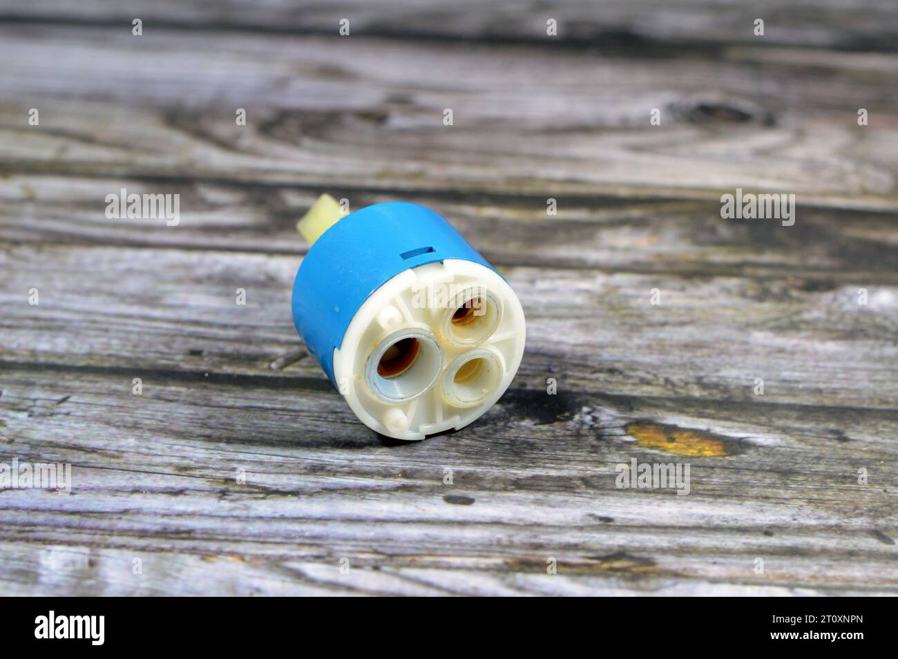 A used broken shower faucet tap body cartridge parts of plastic that